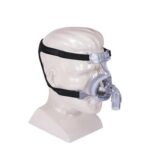 A head mannequin wearing a CPAP nasal mask with head straps for sleep apnea therapy.