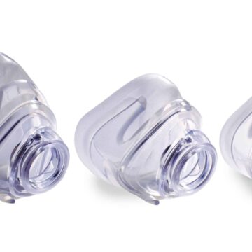 Three clear plastic medical masks of different sizes are displayed side by side on a white background.