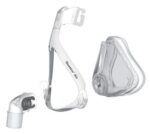 Three separate parts of a clear CPAP mask, including frame, cushion, and elbow connector, on a white background.