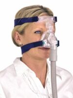 Woman wearing a CPAP mask with head straps and a hose, used for sleep apnea treatment.