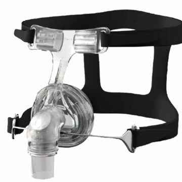 Clear plastic CPAP nasal mask with black adjustable headgear straps, used for sleep apnea therapy.