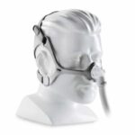 Bust model wearing a CPAP nasal mask with headgear and attached air hose.