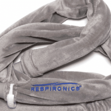 A gray, plush CPAP hose cover with the word “RESPIRONICS” and a blue wave logo on the fabric.