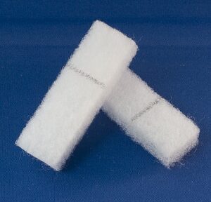 Two rectangular white scrub pads are displayed against a blue background.