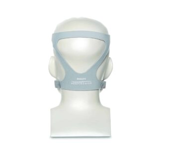 Back view of a mannequin head wearing a gray Philips Respironics CPAP headgear.
