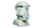 A mannequin head displays a clear CPAP mask with head straps for sleep apnea therapy.
