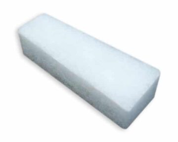 A rectangular white pumice stone block on a white background.