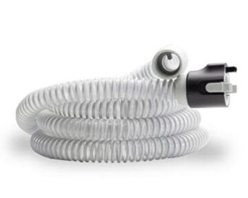White flexible CPAP hose with black and gray connectors, coiled on a white background.
