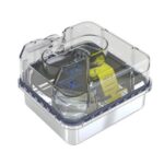 Clear plastic CPAP humidifier chamber with a yellow label and blue markings inside.