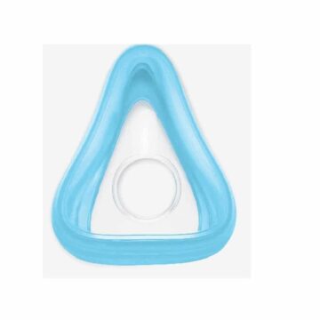 Blue triangular medical face mask cushion with a circular opening in the center, viewed from above.