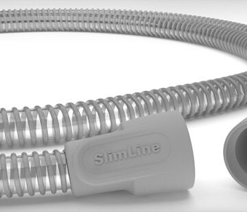 Close-up of a gray, flexible SlimLine medical hose with ribbed texture and connectors at both ends.