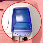 Close-up of a translucent blue water tank on a white appliance, highlighted by a red circle.