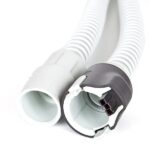 Close-up of a gray and white ribbed hose with plastic connectors on both ends.