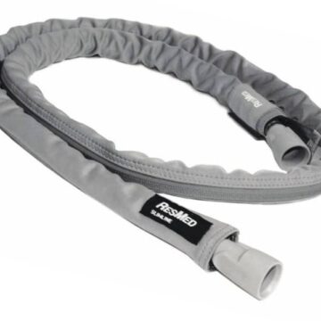 A grey ResMed heated hose cover for a CPAP machine, with plastic connectors on both ends.