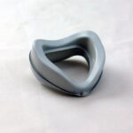 A gray, triangular-shaped silicone mask cushion on a white background.