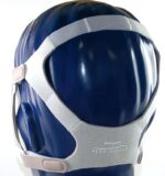 Gray Philips Respironics CPAP headgear fitted on a blue mannequin head, shown from the back.