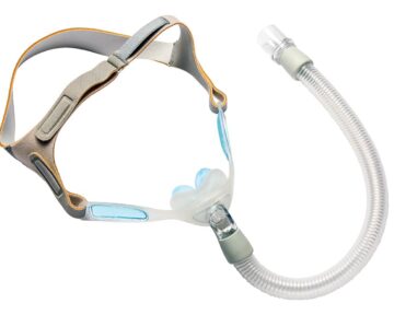 A CPAP nasal mask with head straps and a flexible hose, used for sleep apnea treatment.