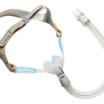 A CPAP nasal mask with head straps and a flexible hose, used for sleep apnea treatment.