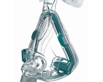 Clear CPAP face mask with headgear clips and a grey connector, used for sleep apnea therapy.