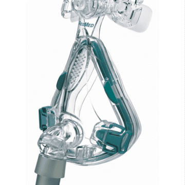 Clear CPAP face mask with headgear clips and a grey connector, used for sleep apnea therapy.