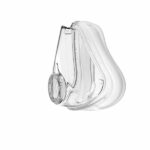 Clear plastic CPAP mask cushion with a circular connector, isolated on a white background.
