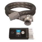 A CPAP machine with a display screen and an attached flexible air hose coiled above it.