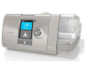 A ResMed AirCurve 10 CPAP machine with a digital display and attached humidifier.