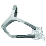 A gray and clear CPAP mask with headgear designed for sleep apnea therapy, shown from the side.