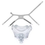 Clear plastic CPAP face mask with attached headgear straps displayed above it on a white background.