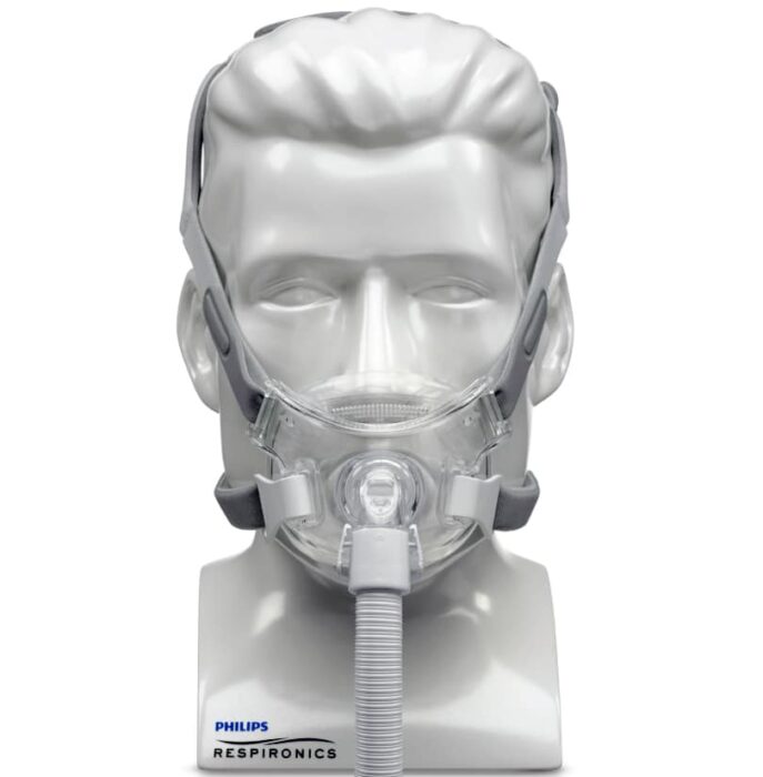 A CPAP mask fitted on a mannequin head, with Philips Respironics branding visible at the base.