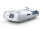 A white CPAP machine with a display screen and water chamber, used for sleep apnea therapy.