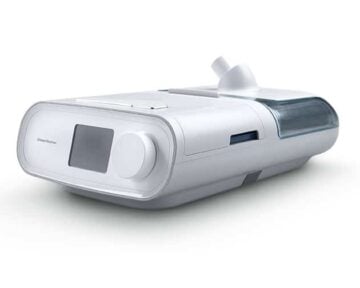 A white CPAP machine with a display screen and water chamber, used for sleep apnea therapy.