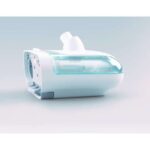 A white and turquoise medical device humidifier with a transparent water chamber on a light background.