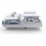 White medical device with a transparent water chamber and open ports on a clean, white background.