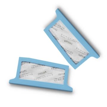 Two blue rectangular filters labeled “Philips Respironics” on a white background, positioned diagonally.