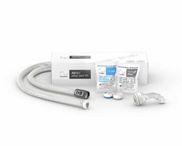CPAP tubing, filters, and humidifier accessories displayed in front of a ResMed AirMini setup pack box.
