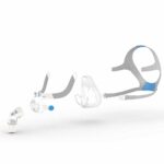 Exploded view of a CPAP mask showing its individual components on a white background.