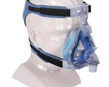 Clear mannequin head wearing a CPAP full face mask with blue and clear straps and headgear.