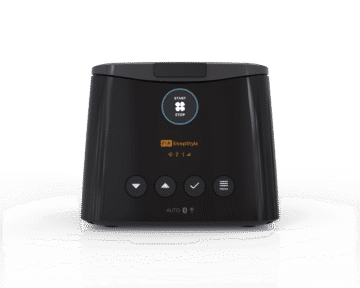 A black F&P SleepStyle CPAP machine with control buttons and a digital display on the front.