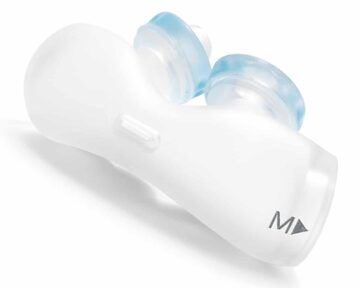 White and blue nasal dilator device labeled "M" on one end, designed to fit inside the nostrils.