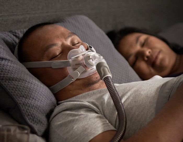 A man and woman using the ResMed AirFit F30 Full Face CPAP Mask while sleeping.