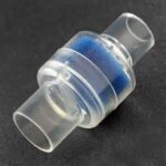 A clear plastic container with blue sand in it, featuring a Z1 Heat Moisture Exchanger for CPAP Machines.