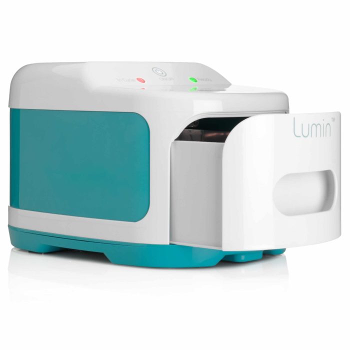 A Lumin UVC Sanitizing System (Mask & Accessories Cleaner) is sitting on top of a white surface.