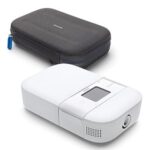 A white Phillips Respironics Dreamstation Go Heated Humidifier next to a black case.