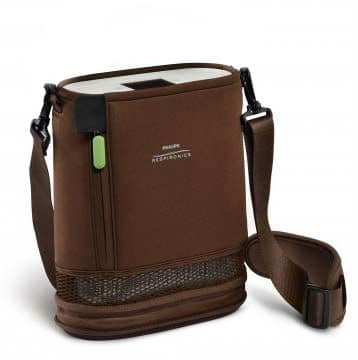 A portable Respironics Simply Go Mini Portable Oxygen Concentrator with Extended Life Battery cooler bag with a strap.