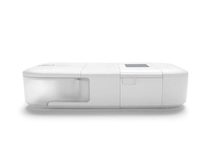 A small white Phillips Respironics Dreamstation Go Heated Humidifier on a white surface.