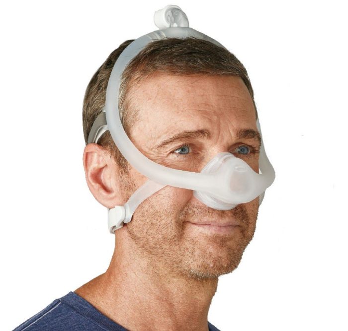 A man wearing a Respironics DreamWisp Nasal CPAP Mask (Fit Pack).