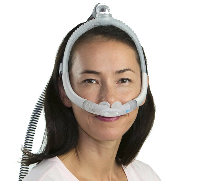 A woman wearing a cpap mask, specifically the ResMed AirFit P30i Nasal Pillow CPAP Mask for her.