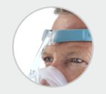 A man wearing a Fisher & Paykel Vitera Full Face CPAP mask.