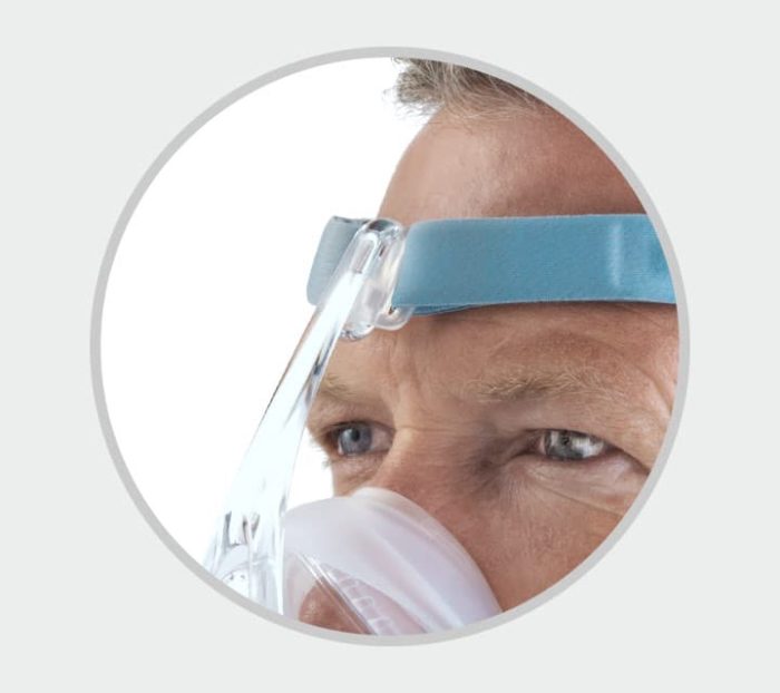 A man wearing a Fisher & Paykel Vitera Full Face CPAP mask.